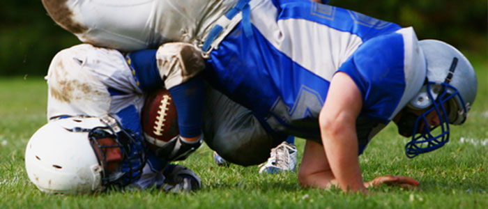 two football players falling on the ground